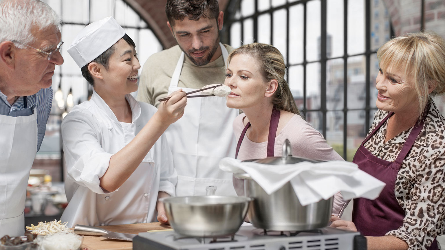 woman-smelling-ingredient-in-cooking-class-2024-09-14-19-59-03-utc
