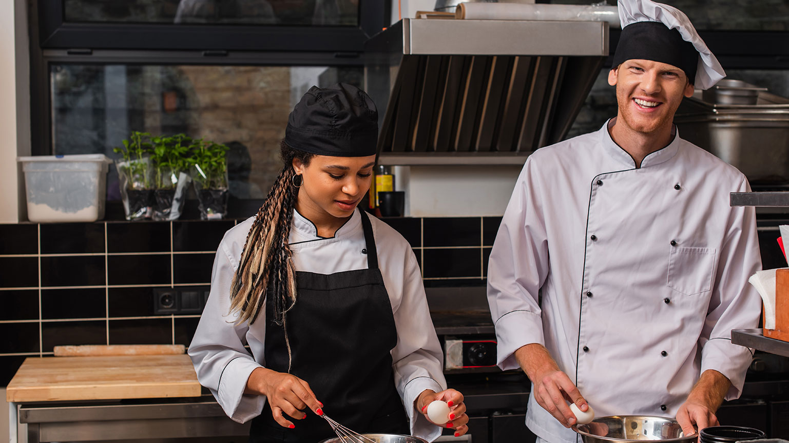 young-african-american-sous-chef-in-apron-holding-2024-11-16-04-17-38-utc